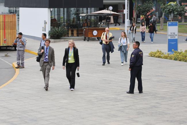Delegates arrive to the venue. 