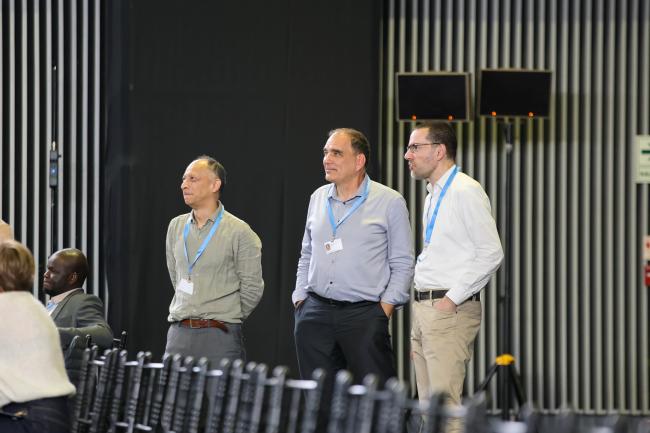 Delegates follow the session from the back of the room 