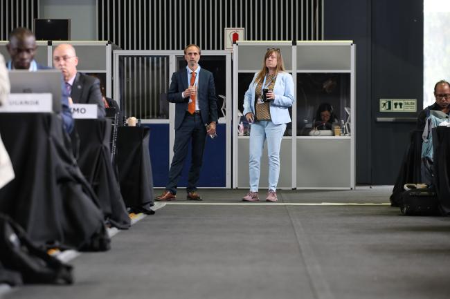 Delegates follow the session from the back of the room 