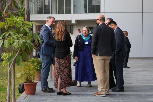 Delegates consult before the evening plenary session.