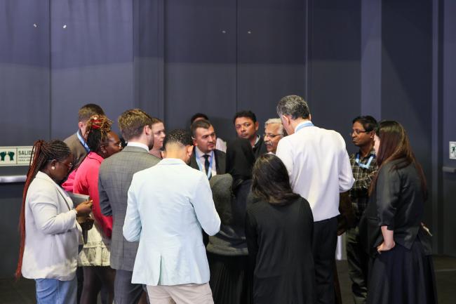 Huddle before the start of the afternoon plenary 