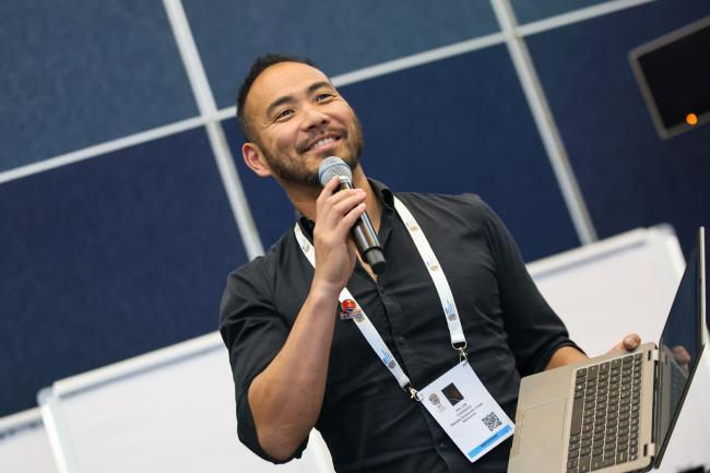 A participant posing a question to the members of the panel