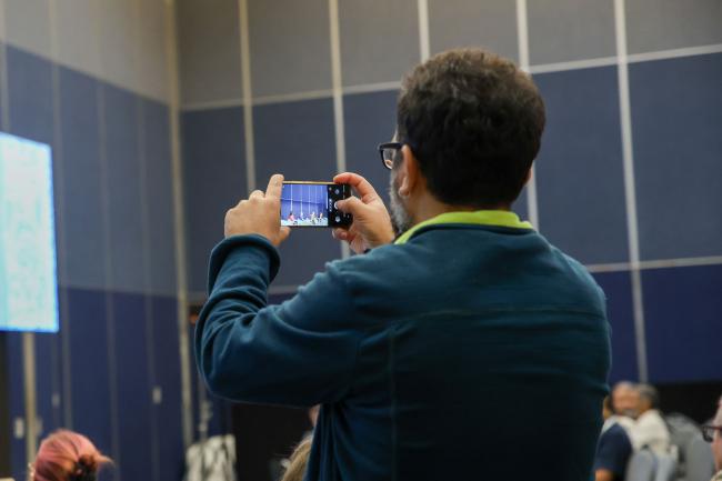 A participant takes a pictures of the panel 