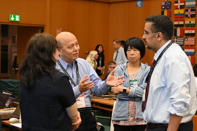 POPRC member Xuezhi Xiao, China, and incoming POPRC member Mohammad Ateeq AlDosari, Saudi Arabia, conferring with observers from China  - PRPC21- 1Oct2025