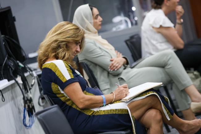 A participant takes notes. 