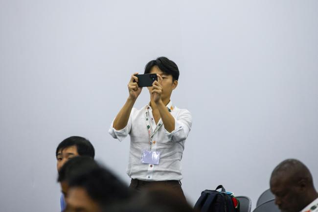 A participant takes a picture. 