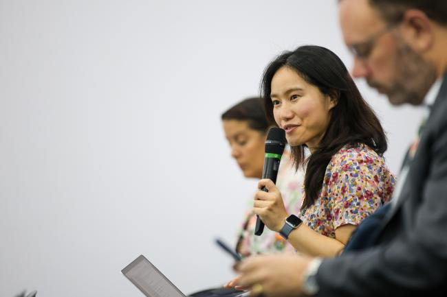 A participant poses a question to the panelists.  