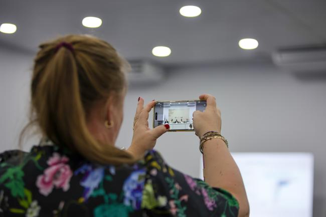 A participant takes a photo of the panel 