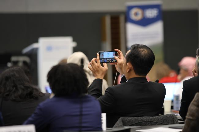 A delegate takes a pictures of the screen 