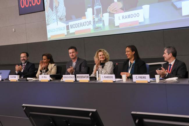 Members of the panel applause following the closing of the meeting. 