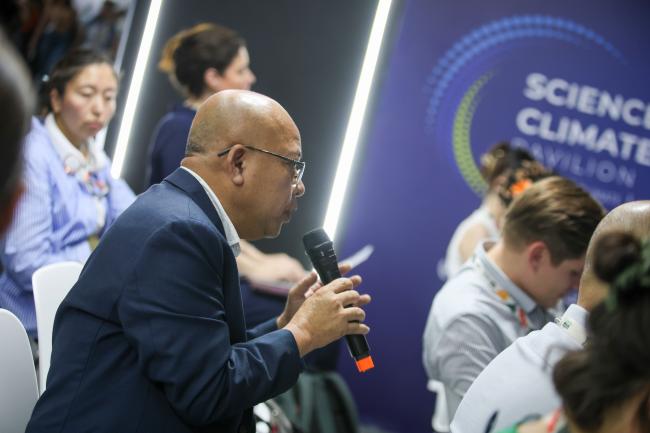 A participant poses a question to the panelists. 