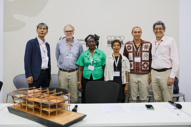 Speakers pose for a family photo. 