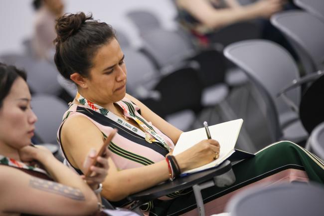 A participant takes notes