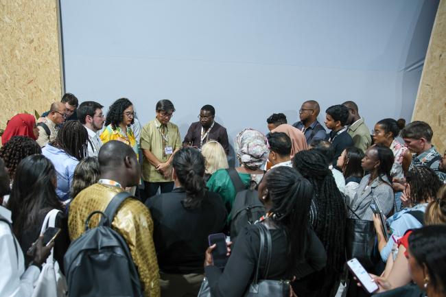 Delegates forming a huddle in the COP 30 hallways