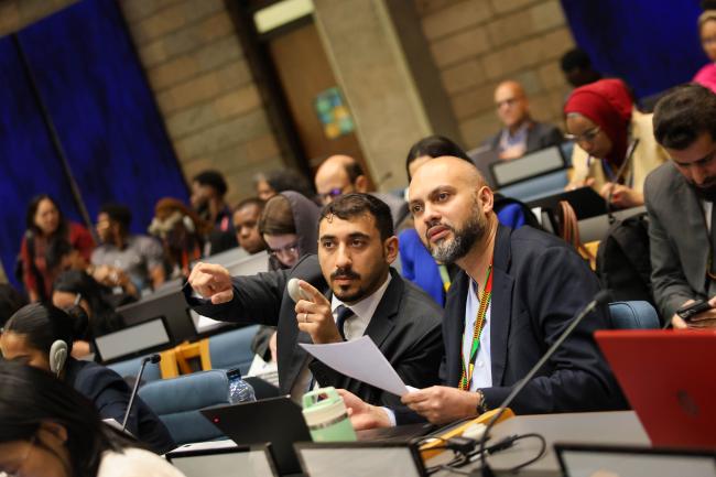 Delegates from Saudi Arabia consult 