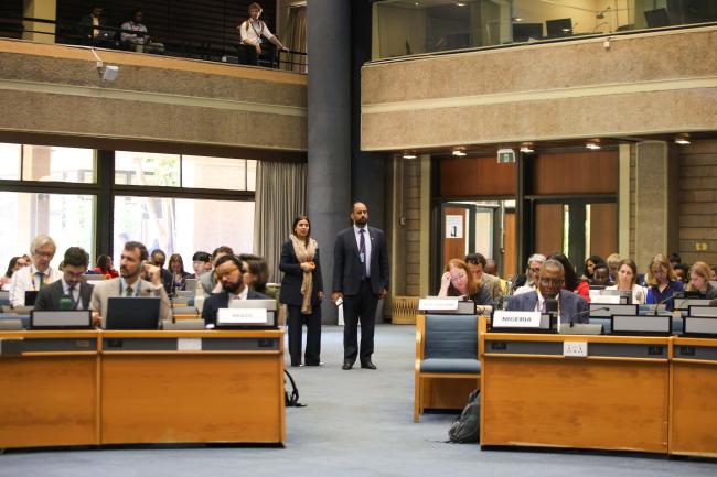 Delegates follow the discussions from the back of the room 