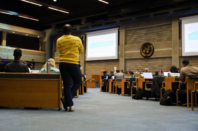 A delegate follow the session from the back of the room. 