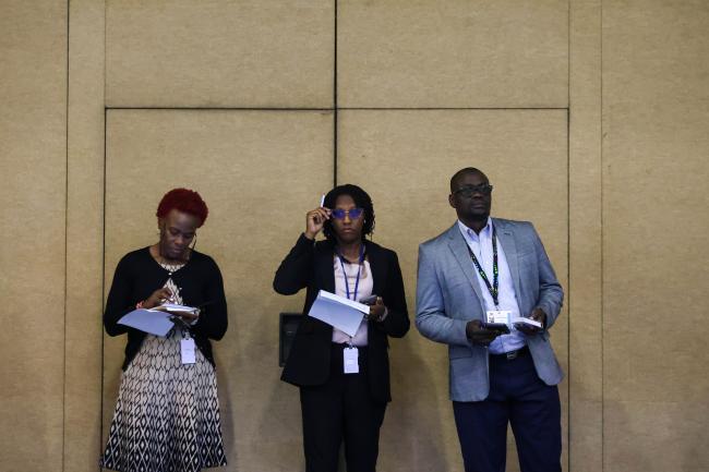 Delegates listen to the discussions. 