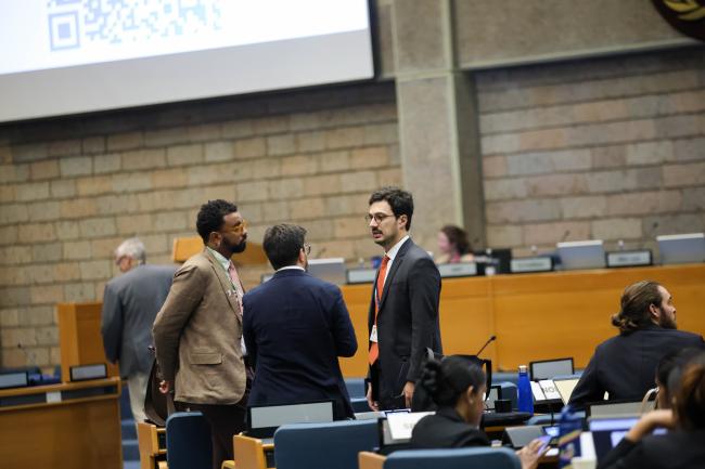 Delegates consult before the morning sessions. 