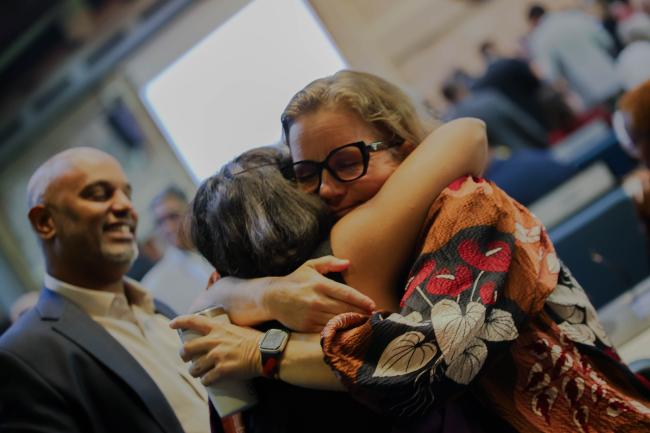 Delegates hug. 