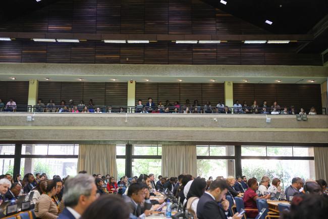 Delegates follow the proceedings from the gallery.