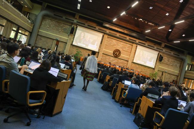 A delegate walks into the plenary room