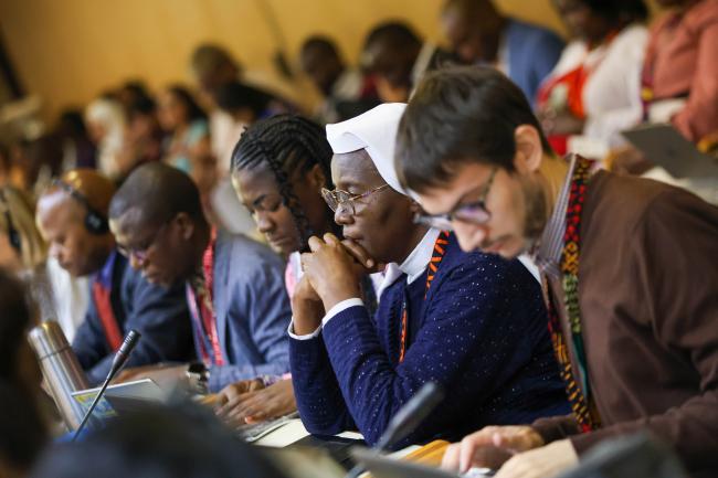 Delegates listen to the opening statements. 