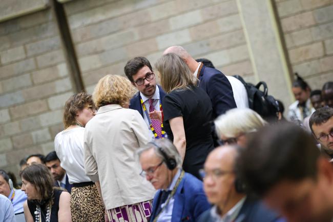 Delegates consult during the closing plenary 