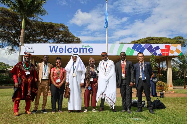 Youth delegates from different countries pose for a family photo. 