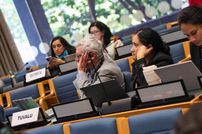 Delegates from Tuvalu listen to the discussions. 
