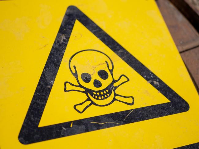 Black and yellow poison sign