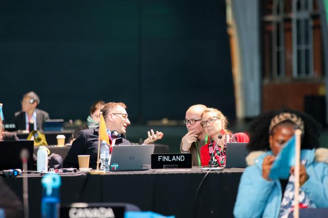 Delegates from Finland discuss during the session.