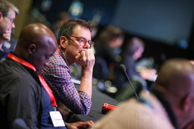 Delegates listen to the discussions.