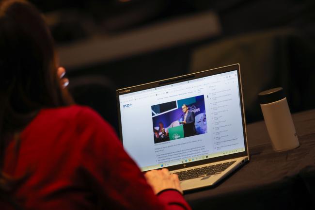 Delegates read the ENB webpage.