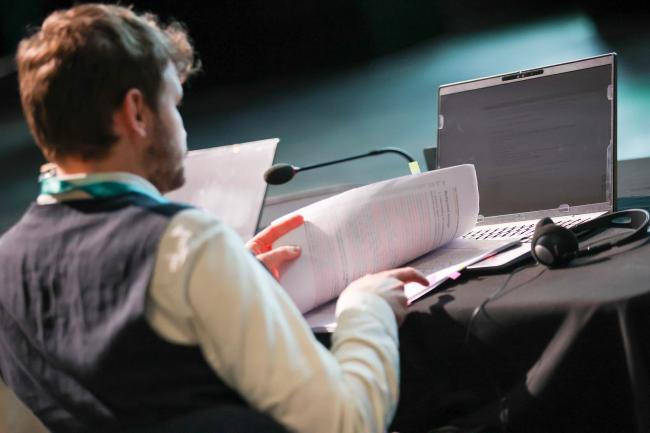 A delegate reviews a draft of the discussed text.