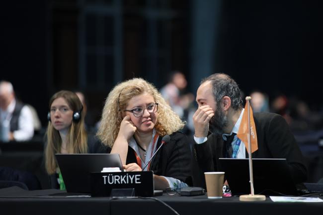 Delegates from Türkiye consult. 