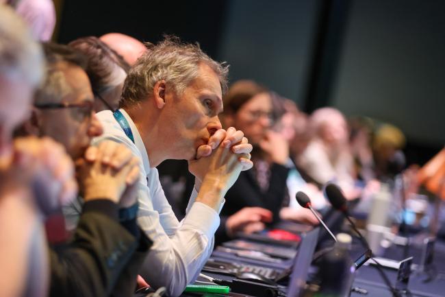 Delegates follow the proceedings 