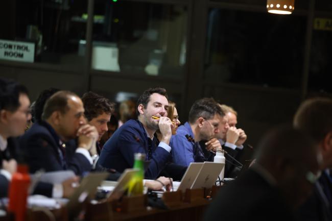 Delegates listen to the discussions. 