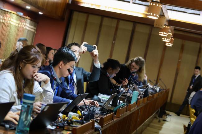 A delegate takes a picture of the screen 