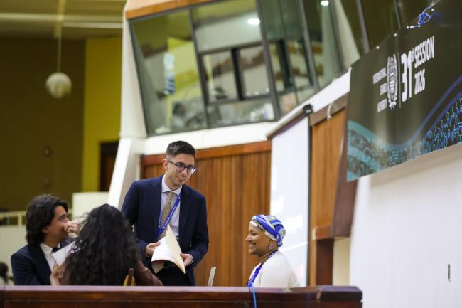 Members of the Secretariat consult. 