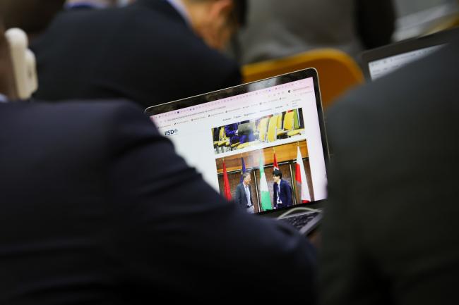 Delegates read the ENB webpage. 
