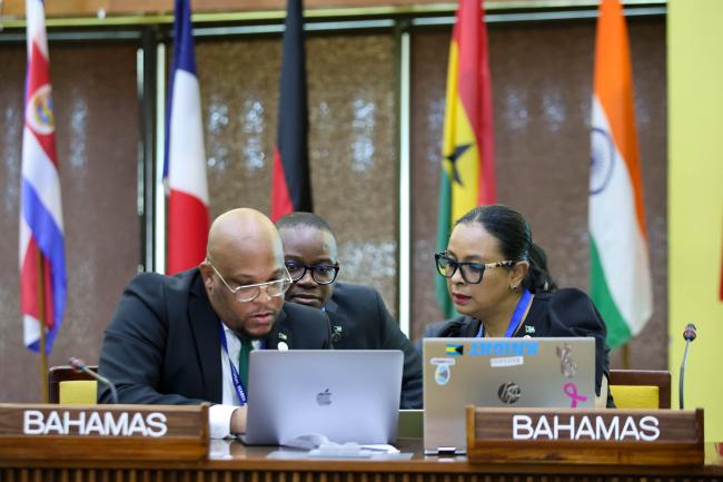 Delegates from the Bahamas consult. 