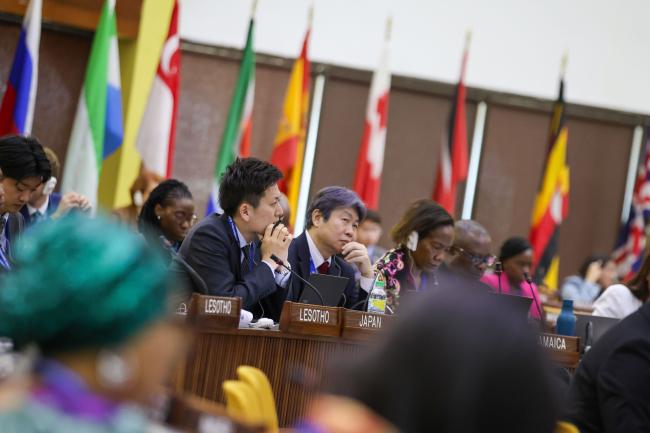 Delegates from Japan listen to the discussions. 