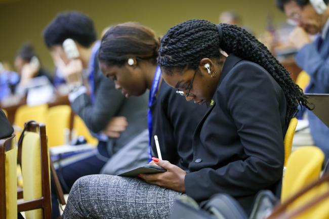 A delegate takes notes.