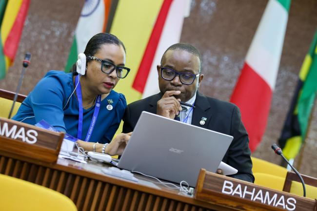 Delegates from the Bahamas consult. 