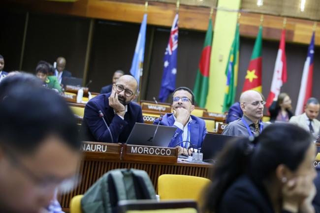 Delegates listen to the discussions. 