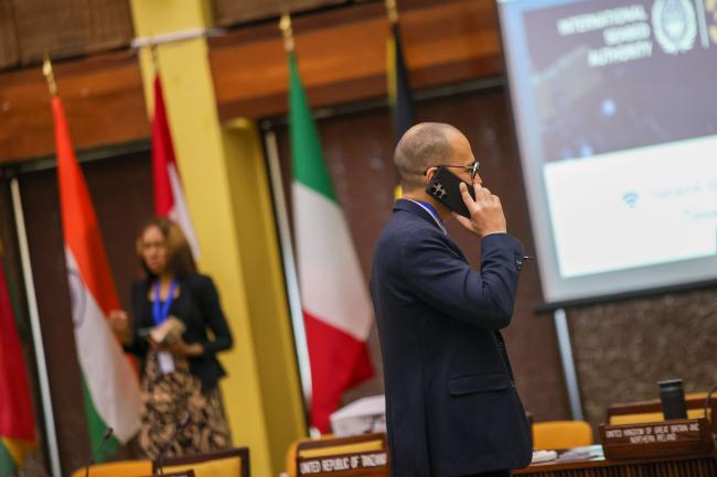 A delegate talks on the phone during the session break.
