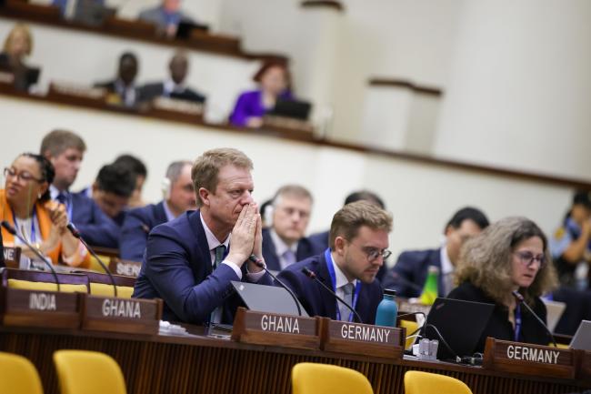 Delegates listen to the discussions. 
