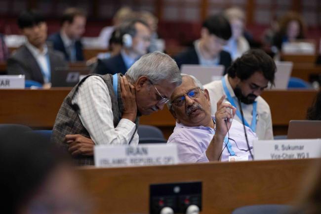 Delegates from India consult. 