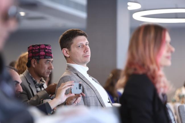 A participant follows the panel discussions